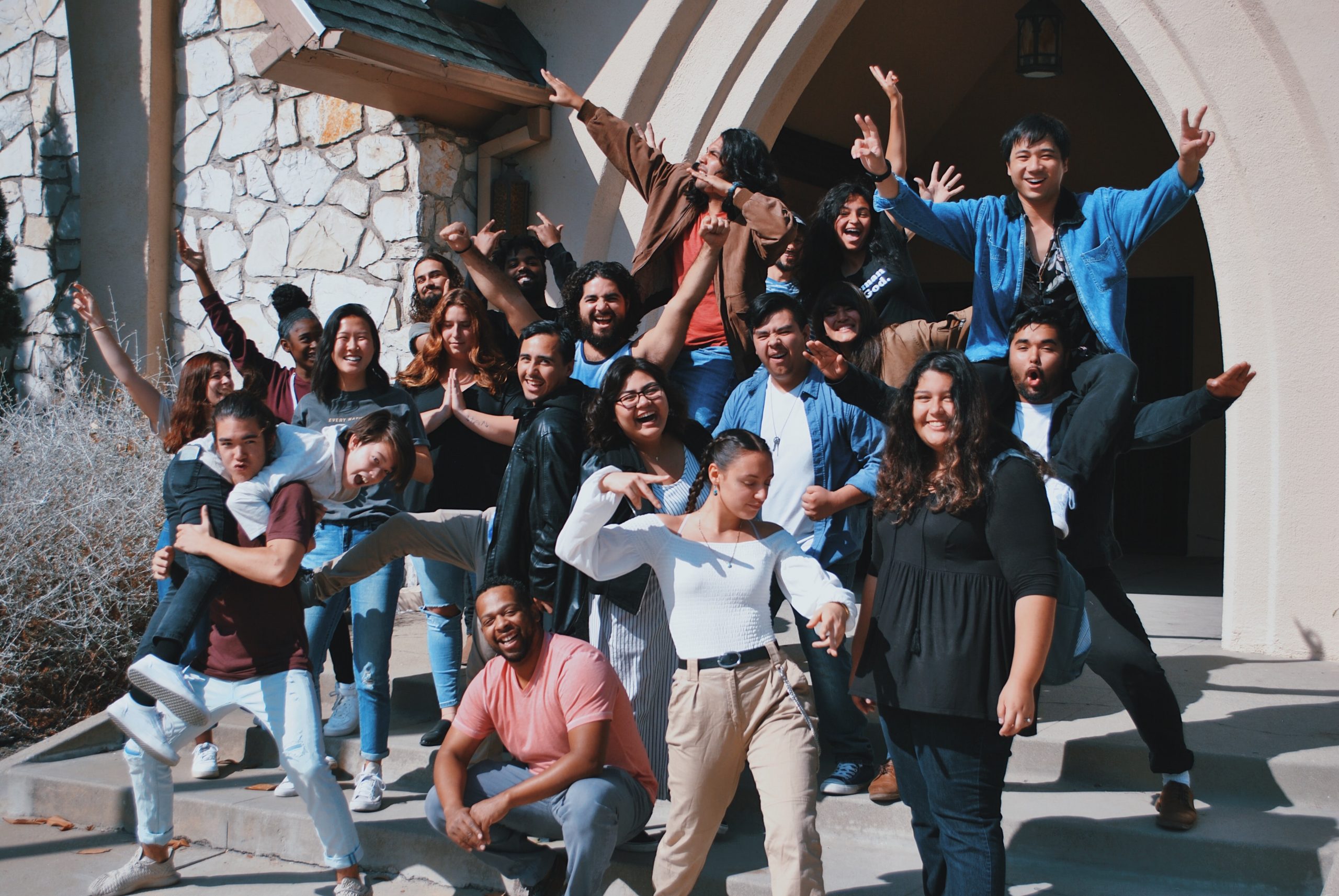 A group photo of young people posing and having fun.